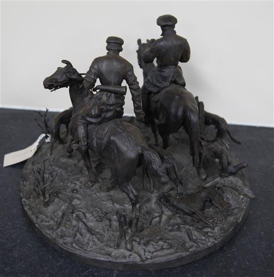 A 19th century Russian cast iron group of two huntsmen and five hounds, width 15in. height 11in.